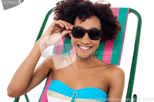 Image of Relaxing female model adjusting her shades