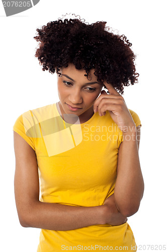 Image of Calm and thoughtful curly haired young woman