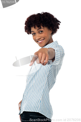 Image of Curly haired casual woman pointing towards you