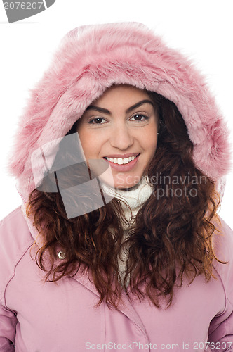 Image of Permed hair woman wearing pink hood winter jacket