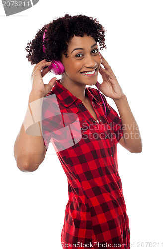 Image of Fun loving girl enjoying lively music