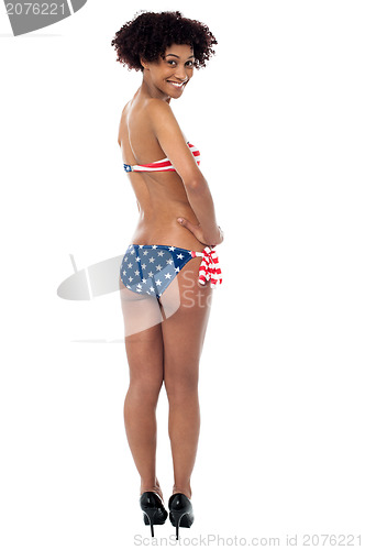 Image of 25 years young woman in swimsuit with american flag