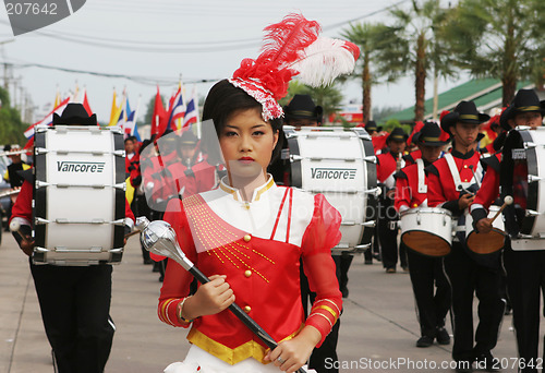 Image of Beautiful young Thai girl leads a marching band during a parade,