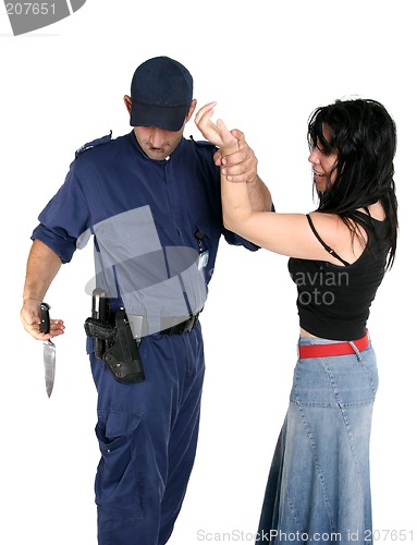 Image of Officer disarms a weapon from a suspected criminal