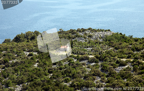 Image of Mediterranean style chapel made of stone by the sea, Croatia