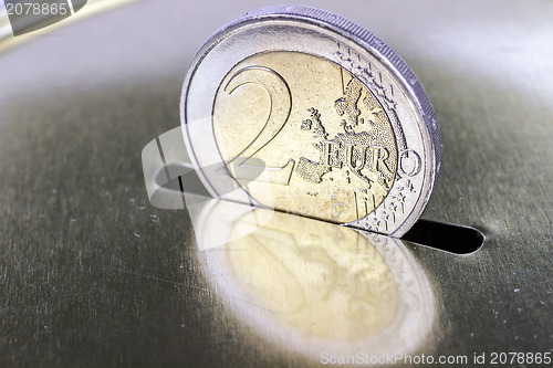 Image of saving two euros in a piggy bank