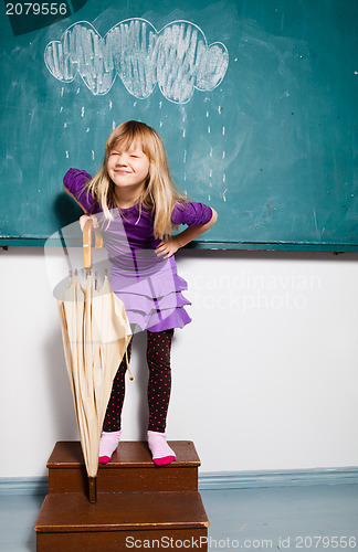 Image of Smiling young girl with umbrella indoors