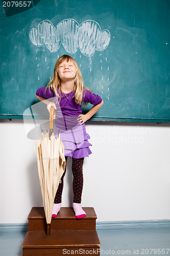 Image of Smiling young girl with umbrella indoors