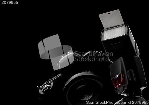 Image of Black background photo camera and flash