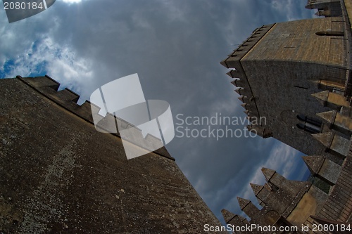 Image of Fisheye view of towers of Almodovar del Rio medieval castle against the cloudy sky