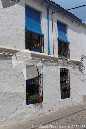 Image of Plastered wall of two-storied Mediterranean house with four windows