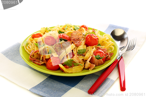 Image of Pasta with bacon, tomatoes and basil.