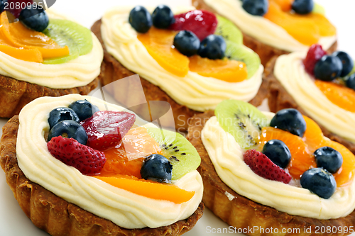 Image of Cream cakes and fruit.