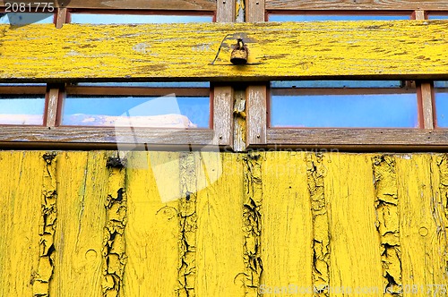 Image of Old window yellow wall closed woody shutter