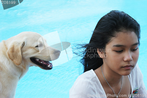 Image of Asian girl with her pet dog (focus is on the girl).