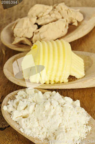 Image of baking ingredients butter, yeast and meal