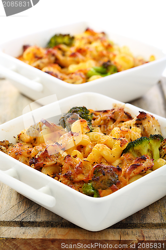 Image of Baked pasta with cheese in a porcelain bowl.