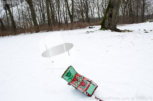 Image of fallen painted bird nesting box lie snow winter 