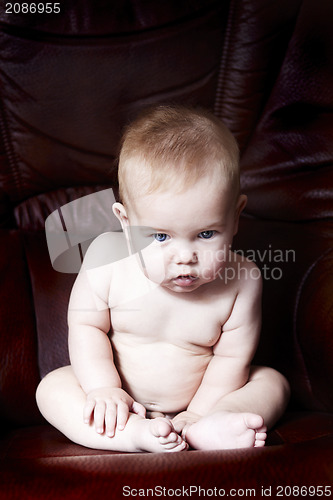 Image of Child sitting on a armchair