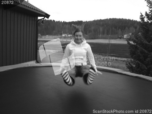 Image of Girl jumping on a trampline