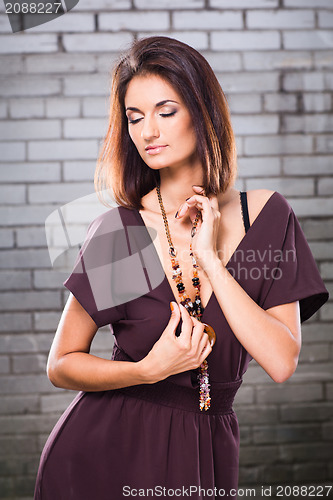 Image of sensual girl posing against brick wall