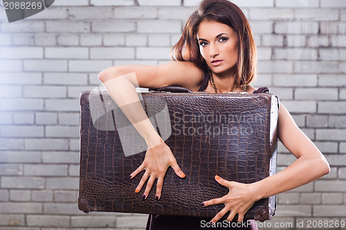 Image of beautiful girl with vintage suitcase waiting at the station
