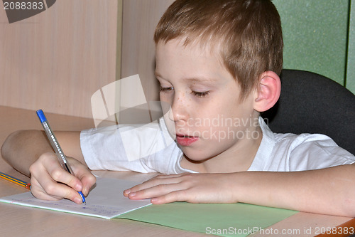 Image of The boy does homework