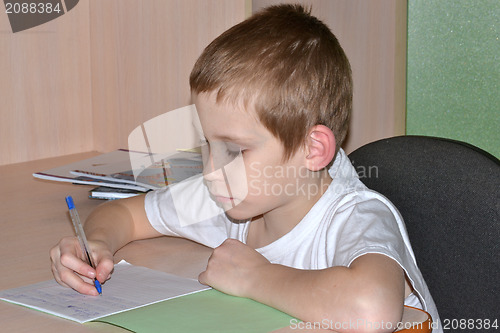 Image of The boy does homework