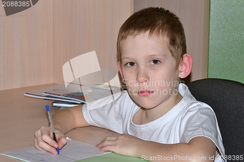 Image of The boy does homework