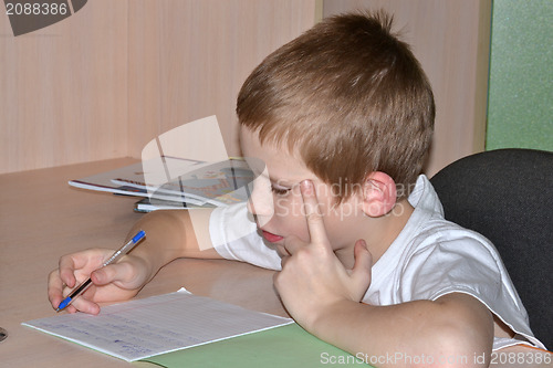 Image of The boy does homework