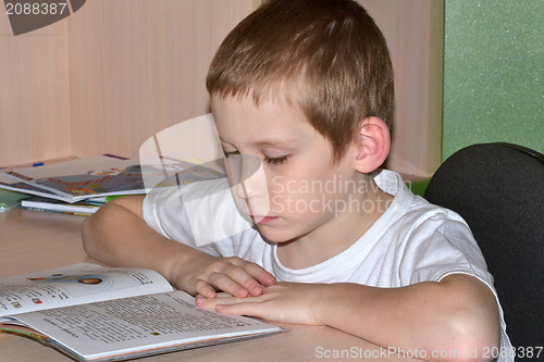 Image of The boy does homework