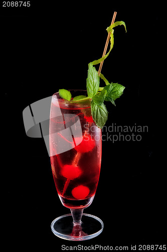 Image of Alcohol red drink, cocktail with mint, cherry, isolated black