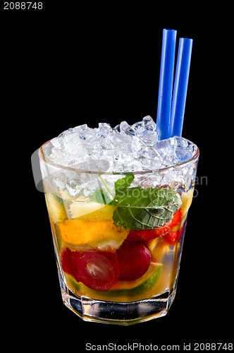 Image of Alcohol drink, cocktail with fruits, ice, isolated black