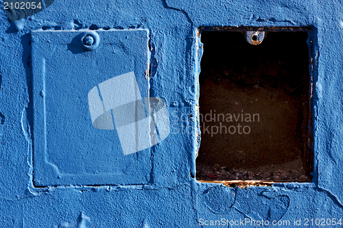 Image of two metal box and a blue wa
