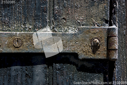 Image of  old iron metal lock screw and wood 