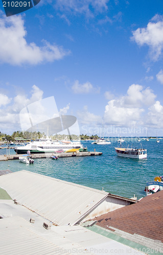 Image of harbor port with jetty hotel passenger ferry  yacht sailboats Cl