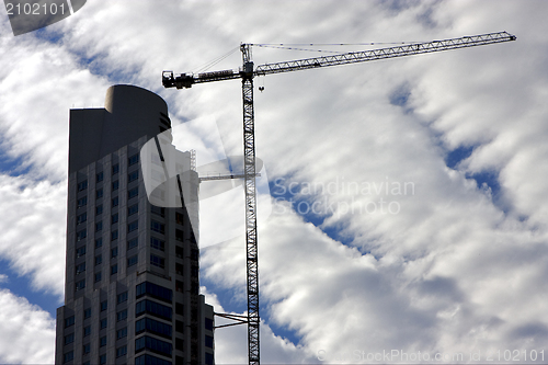 Image of skyscraper clouds and crane 