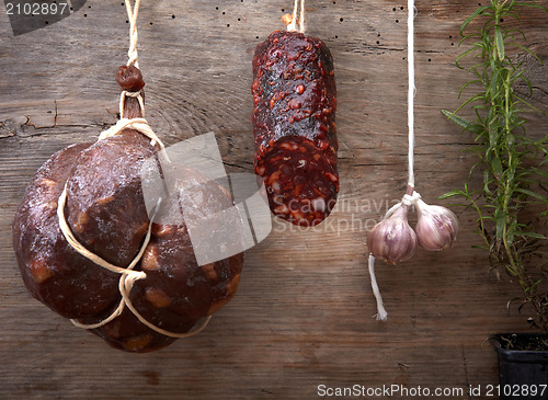Image of various hanging salami sausages