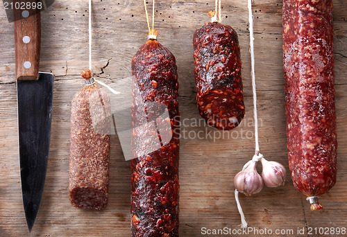 Image of various hanging salami sausages