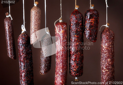 Image of various hanging salami sausages