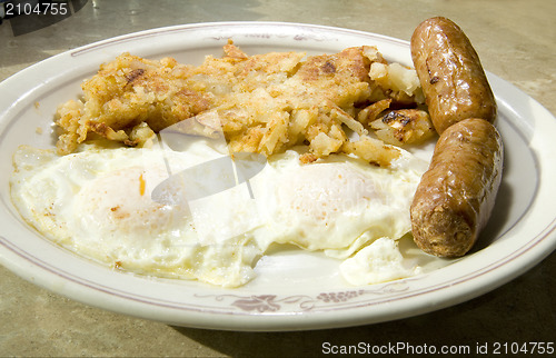 Image of fried eggs over easy pork sausages home fried potatoes breakfast