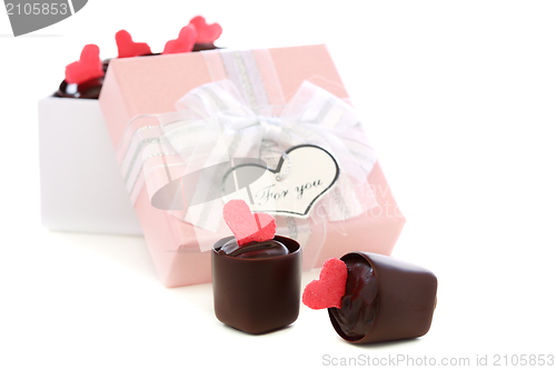 Image of Handmade chocolates and pink box with a bow.