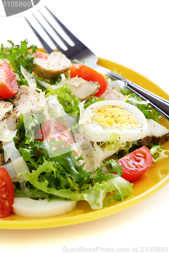 Image of Salad with tomatoes, chicken and Parmesan cheese.