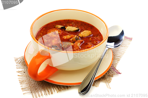 Image of Cup of soup with seafood and tomato. 