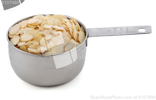 Image of Flaked almonds presented in an American metal cup measure