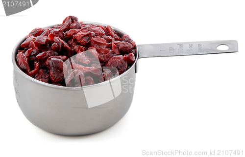 Image of Dried cranberries presented in an American metal cup measure