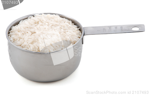 Image of White long grain rice presented in an American metal cup measure