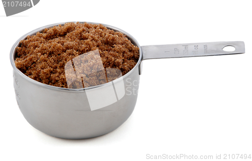 Image of Dark brown soft / muscovado sugar presented in a cup measure