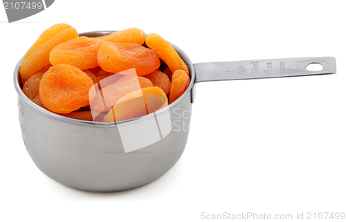 Image of Whole dried apricots presented in an American metal cup measure