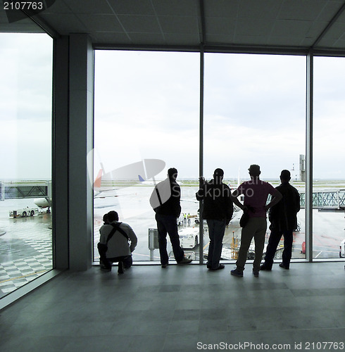 Image of travel people  silhouette looking at planes on runway in airport